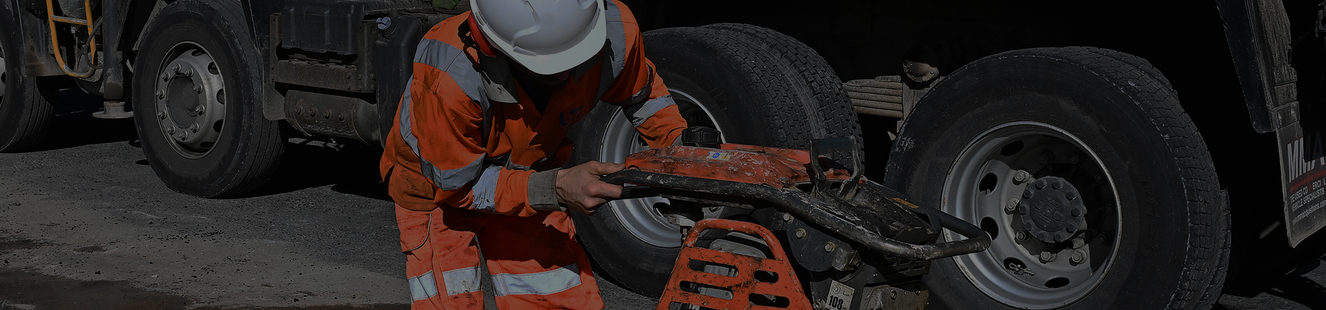 United Networks Group worker with heavy machine on the road