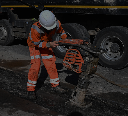 United Networks Group worker with heavy machine on the road